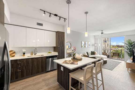A modern kitchen with a dining table and chairs.