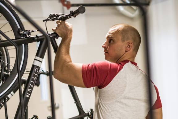 a man removing a bicycle from the dedicated bike storage racks at The Citizen Birmingham