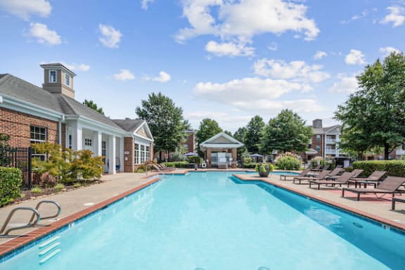 Large pool with landscaping and bank of deck chairs at Centerville Manor Apartments, Virginia