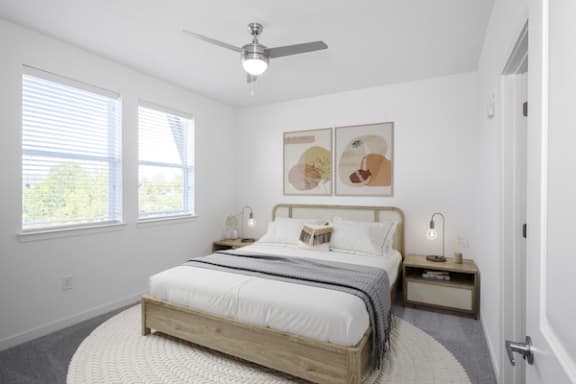 a bedroom with a bed and two windows at Canopy Park Apartments, Pelham, 35124