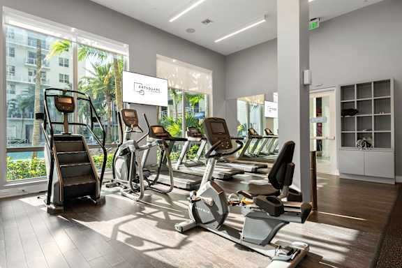A gym with treadmills, exercise bikes and other equipment.