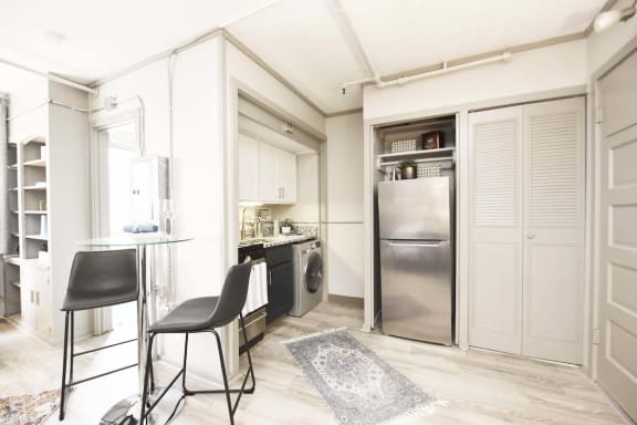 entrance into kitchen with stainless steel appliances and wood-style flooring