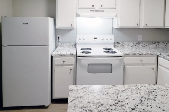 Kitchen with White Appliances at Woodland Villas Apartments in Jasper, AL