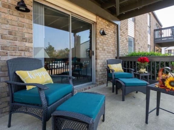 a large apartment patio with model furnishings and sliding glass doors into the home