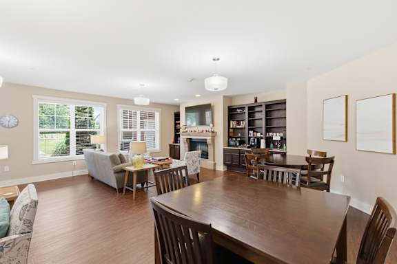 A dining room with a wooden table and chairs.