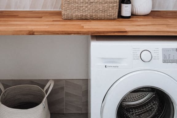 a white washing dryer combo machine in an apartment home