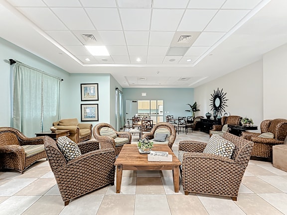 A clubhouse lounge area with chairs and a table