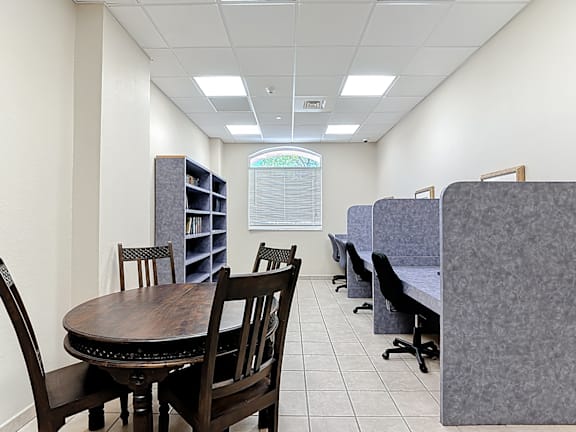 A business center with a table and chairs.