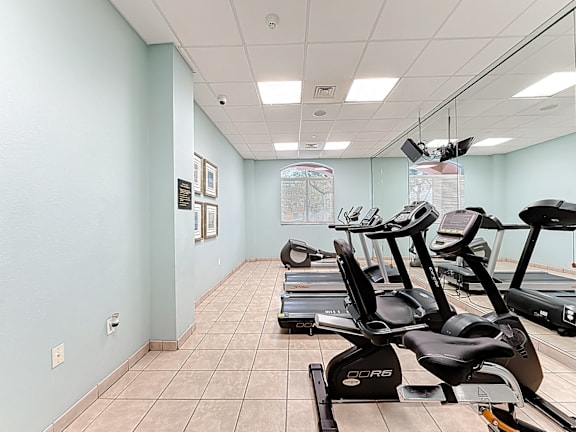 A gym with treadmills and exercise equipment.