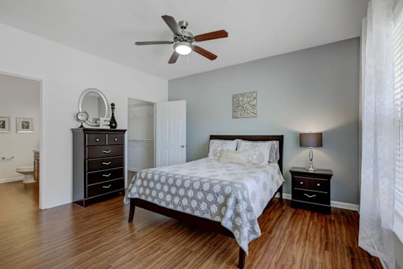 A bedroom with a bed, dresser, and mirror at Ethan Pointe Apartments, Greensboro, NC, 27215