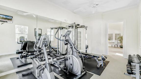 a home gym with a lot of exercise equipment