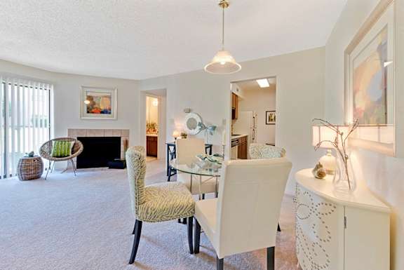 A living room with a fireplace and a chair at Fox Hollow Apartment Homes, North Carolina, 27265
