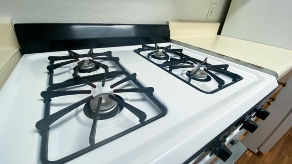 White and black gas stove by white kitchen countertops