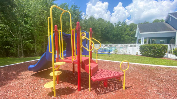 Outdoor Playground equipped with a slide, monkey bars, and latter