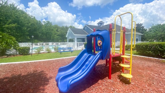 Outdoor Playground equipped with a slide, monkey bars, and latter