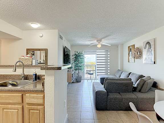 A kitchen with a sink and a couch.