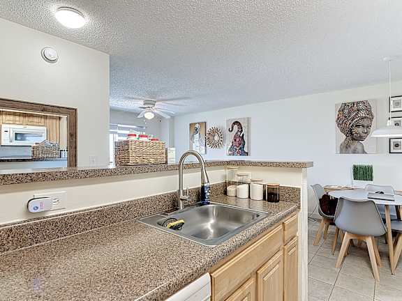 A kitchen with a sink and a counter.