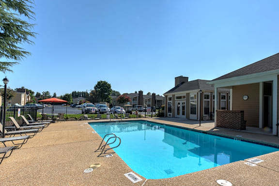 A pool with a blue tiled edge and a white line painted on the ground at Fox Hollow Apartment Homes, High Point, NC