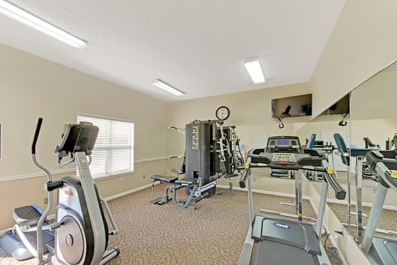 A well-equipped gym with treadmills, exercise bikes, and other fitness machines. at Fox Hollow Apartment Homes, High Point, NC, 27265