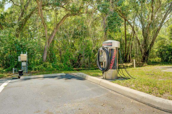 Car wash area with Vacuum machine and water hose with surrounding native landscaping