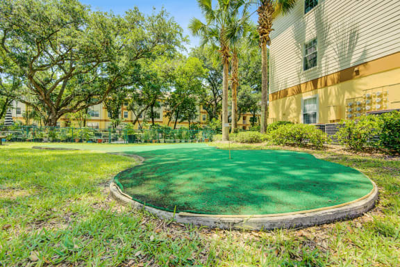 Artificial putting green overlooking the community garden and surrounded by native landscape
