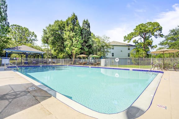 Swimming Pool with Lounge Seating on Sun Deck with Building Exteriors in the Background