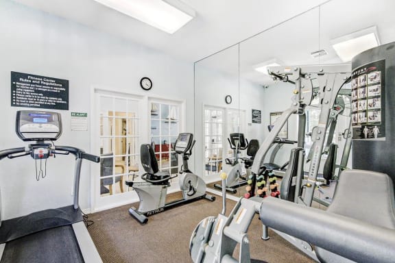 Fitness Center with Exercise Equipment, Mirrored Wall and Educational Posters