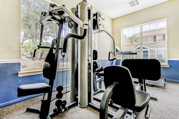 Fitness center with strength training equipment and large windows