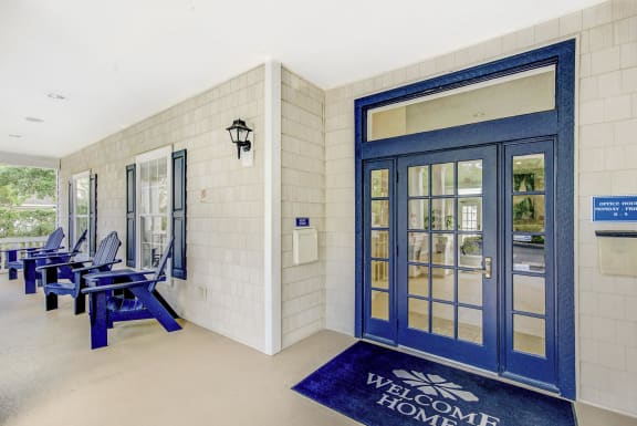a blue door with a welcome mat in front of it