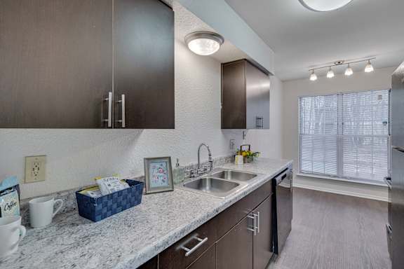 A kitchen with a marble countertop and modern appliances.