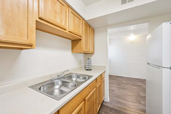 kitchen with wooden cabinets at Bella Vista Apartments, Arizona