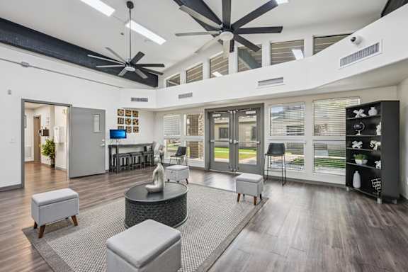 clubhouse with ceiling fans and chairs.