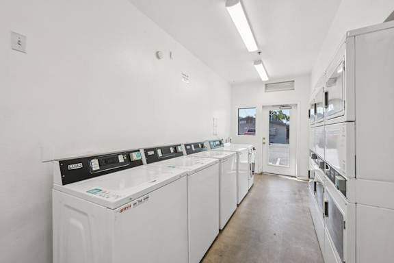 A row of washing machines in a laundromat.