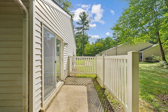 apartment patio with a white fence