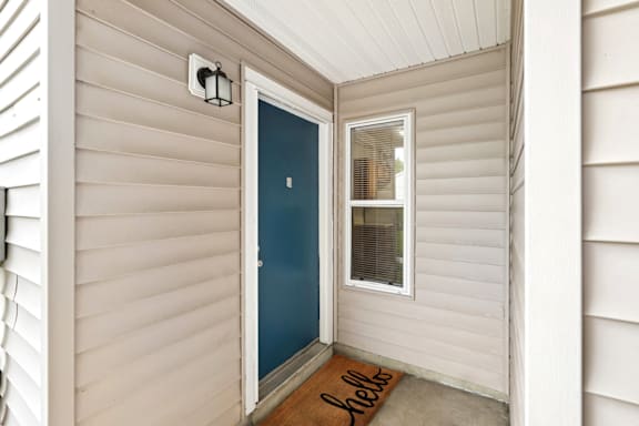 apartment door with a small window next to it