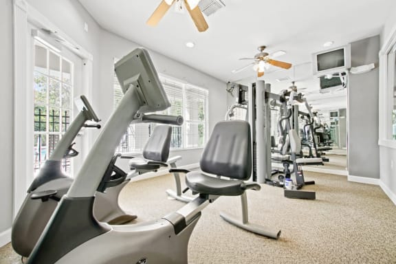 Fitness center with exercise machines facing a mirror