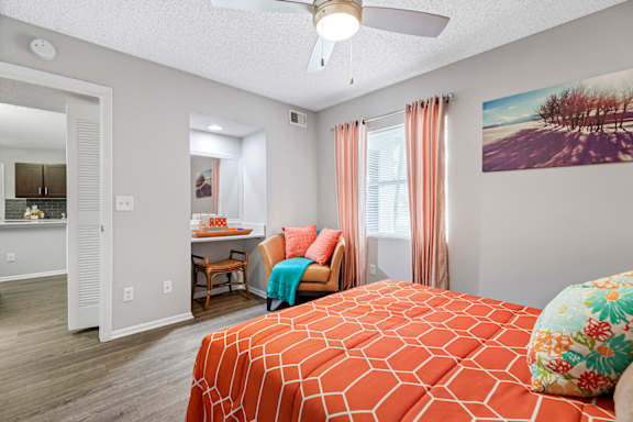bedroom with ceiling fan and built-in desk area