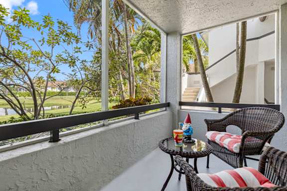 A balcony with a table and chairs