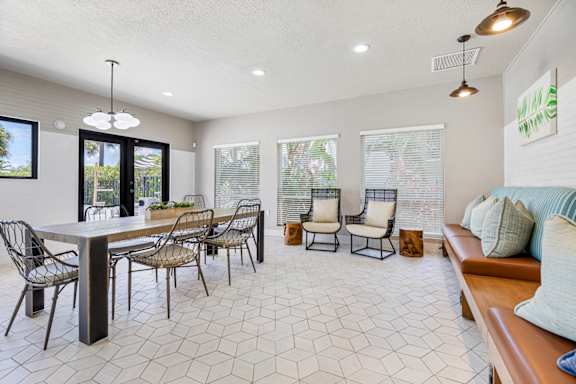 resident clubhouse with tables, chairs, and booths