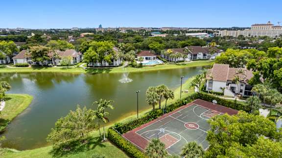apartment community with a view of a lake and sports court