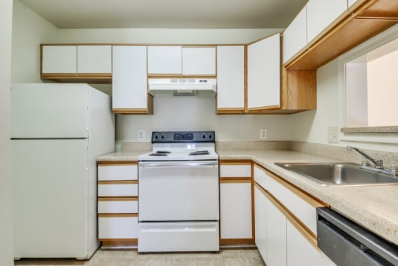a kitchen with white cabinets and white appliances