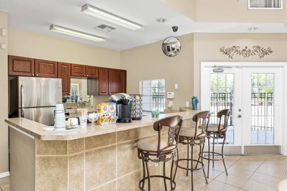 Interior or resident clubhouse facing kitchen and breakfast bar area