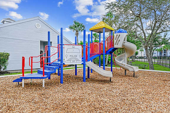 Playground area with wood chips and natural landscaping