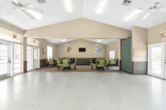 Interior of resident clubhouse facing large interior space with chairs and tables