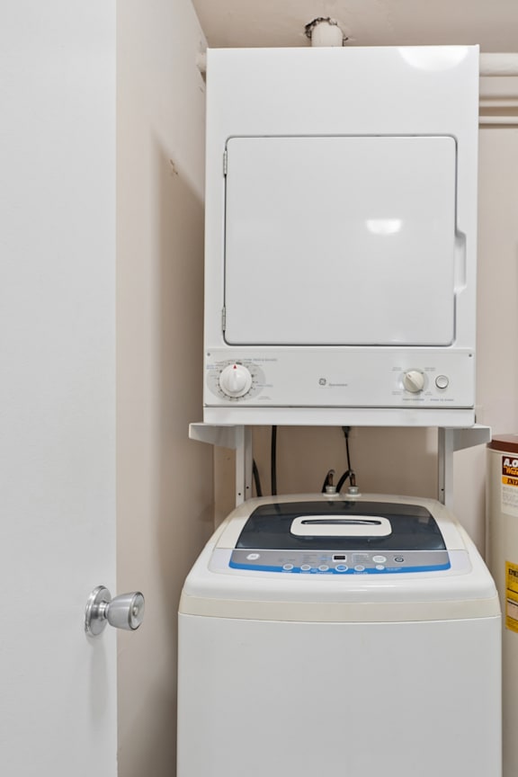 A white dryer and washer are mounted on a wall.
