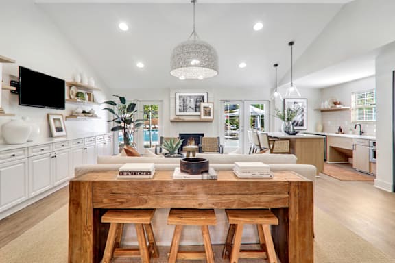 a kitchen and living room with a large wooden table in the middle of the room at Caveness Farms Apartments, North Carolina