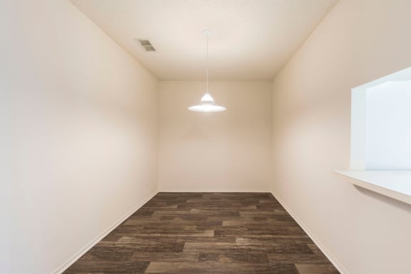 Dinning room with wood style flooring and hanging pendulum light