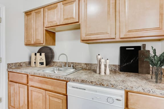 the kitchen at the enclave at woodbridge apartments in sugar land, tx