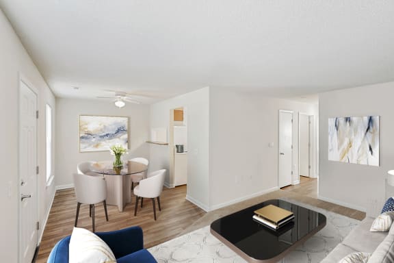 a living room and dining room with white walls and hardwood floors