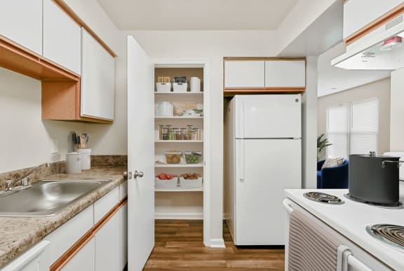 a kitchen with white appliances and white cabinets